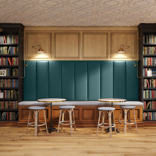 Bar area with wooden cabinets, teal paneling, and bar stools in a cozy setting.