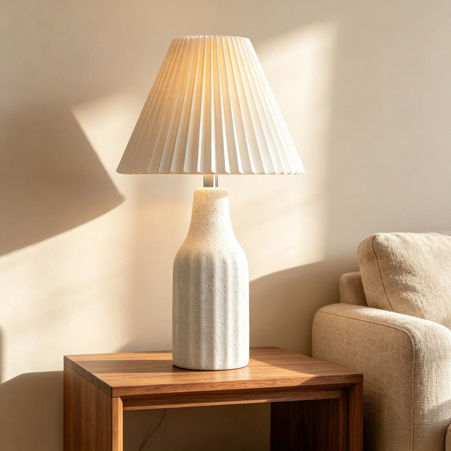 Pleated Shade Ceramic Lamp on a side table beside a sofa