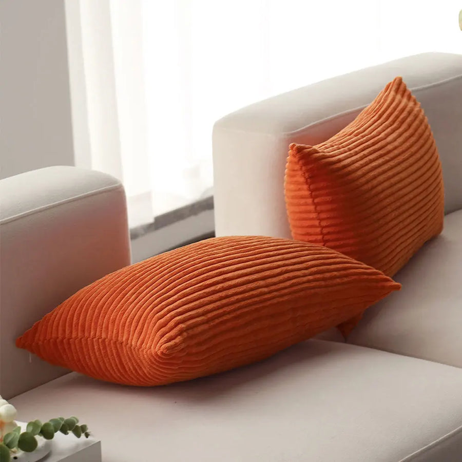Corduroy Lumbar Pillow Cover in orange on a light sofa