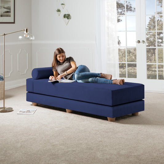 Woman lying on Alon Convertible Daybed with Wood Feet - Microvelvet Indigo