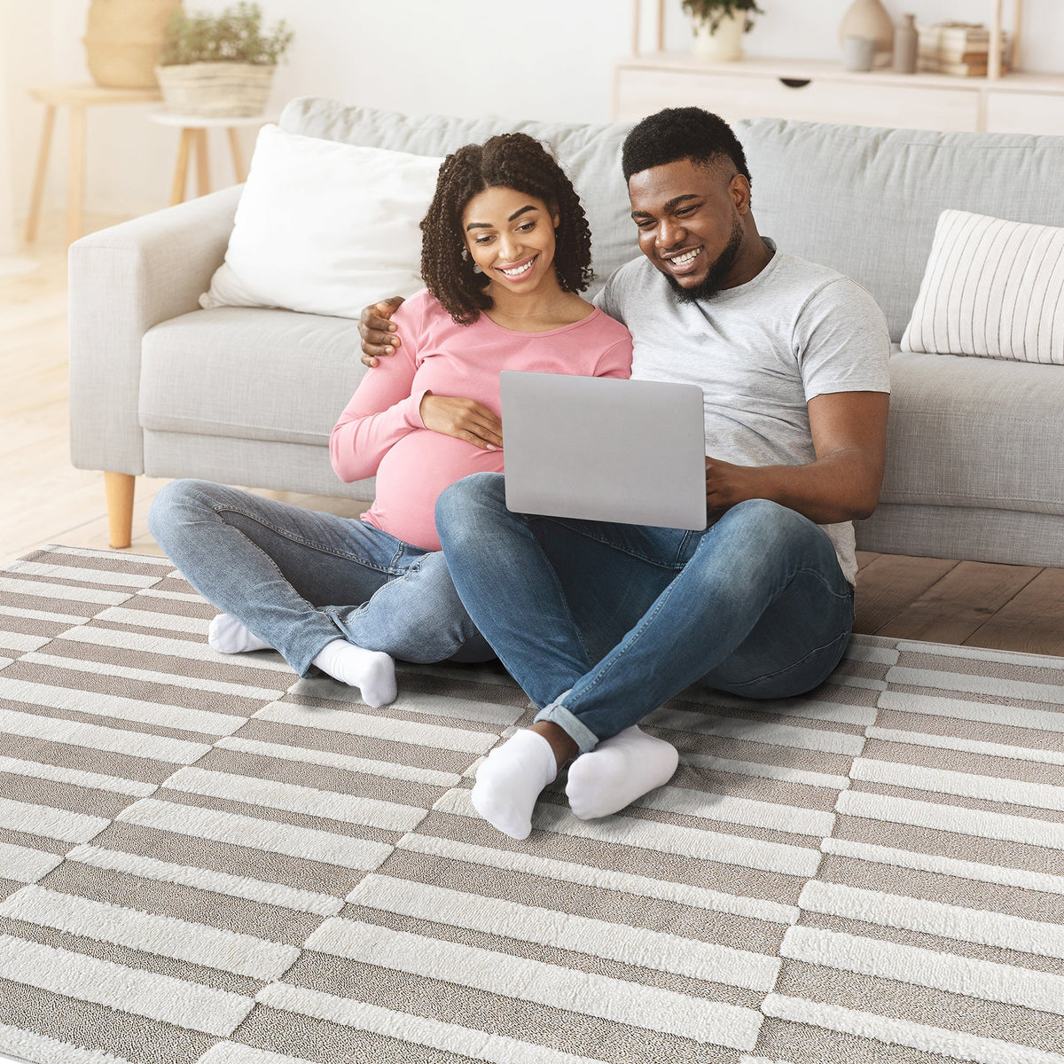 Couple relaxing on the beige striped rug