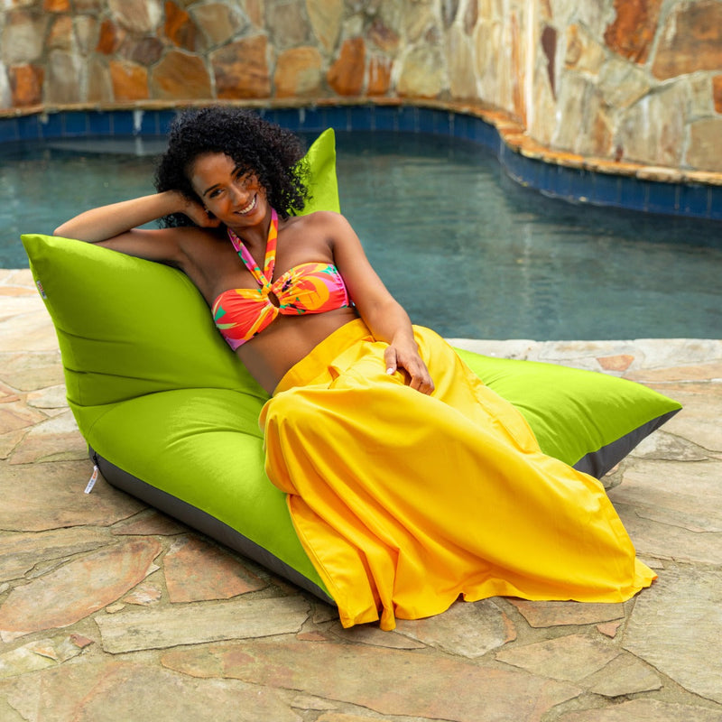 Woman sitting and smiling on the Finster Outdoor Bean Bag Lounge Chair in Lime