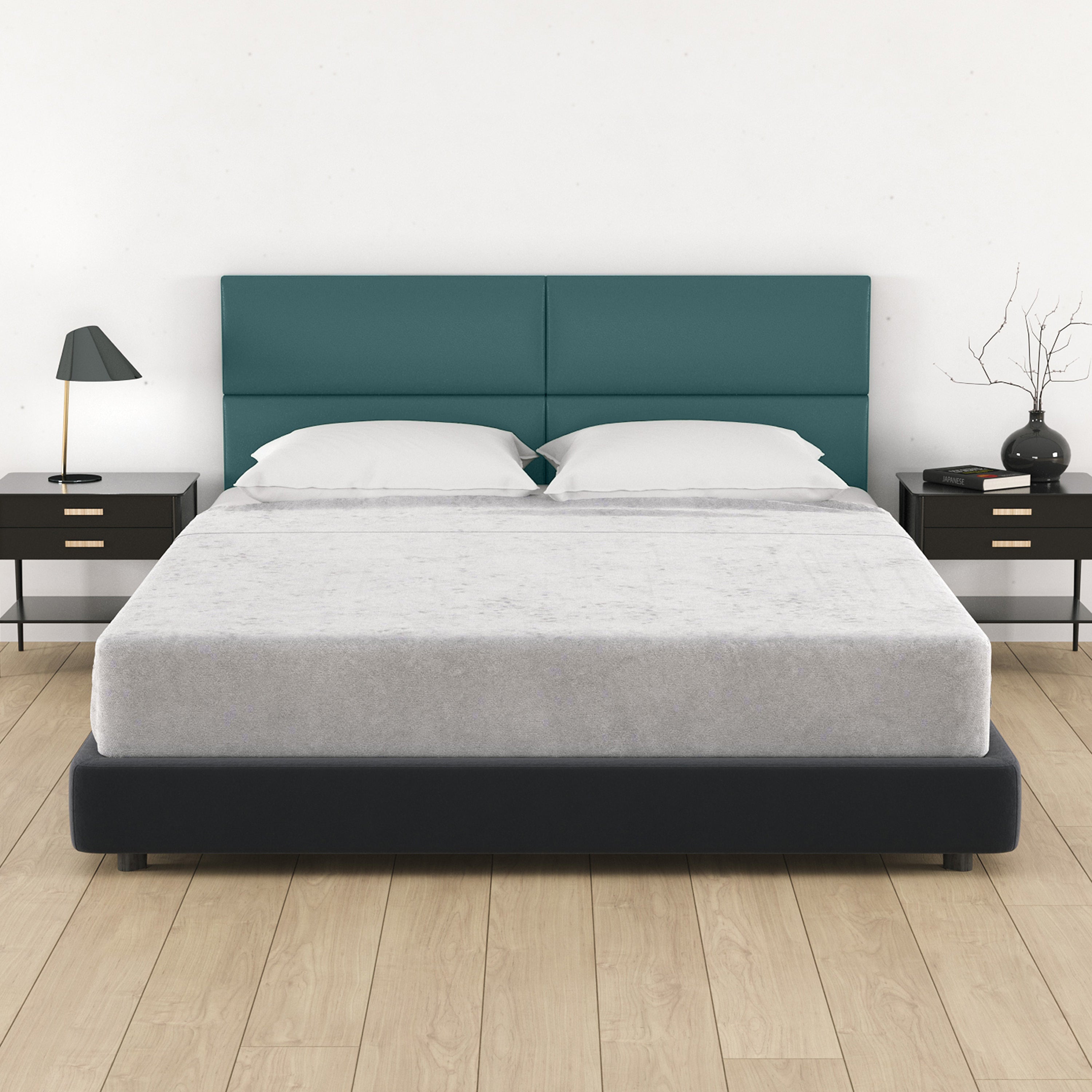 Bed with teal headboard and white bedding in a bedroom setting