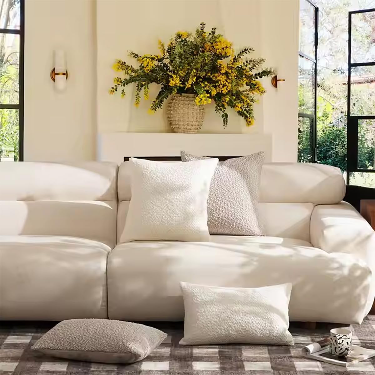 Boucle throw pillows styled on a cream sofa