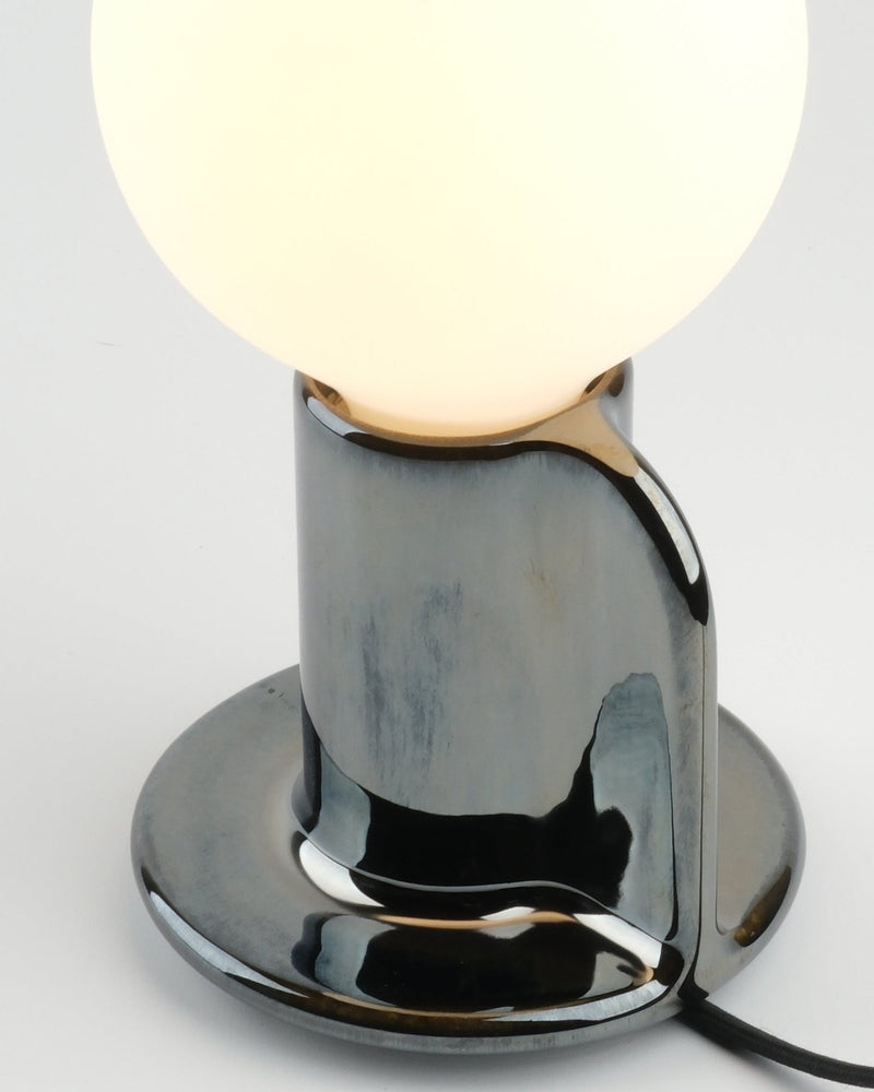 Close-up of the chrome Q Lamp