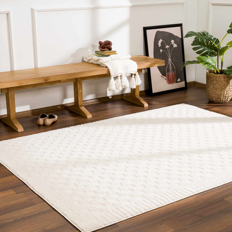 Ivory checkered rug in front of a wood bench