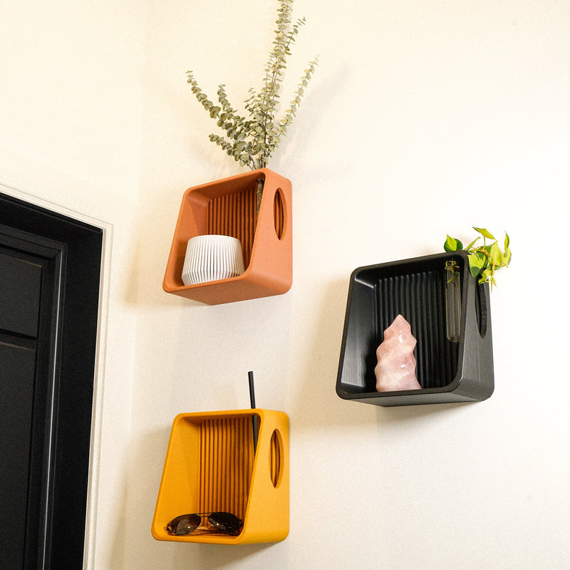 Ribbed Wall Shelf in orange, black and mustard on a wall