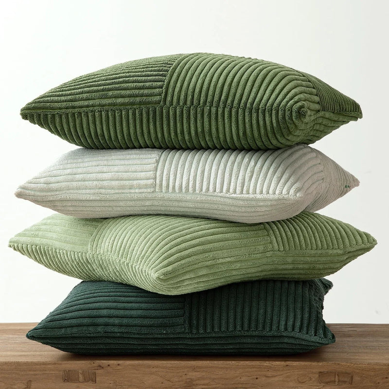 Stack of green and cream corduroy pillows