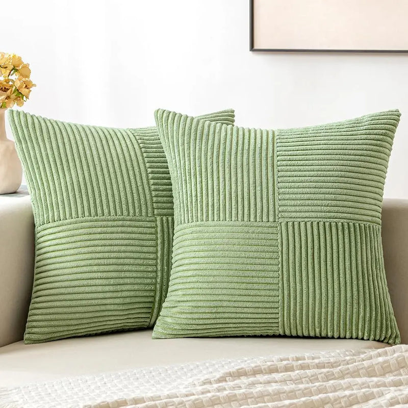 Green corduroy pillow covers on a sofa