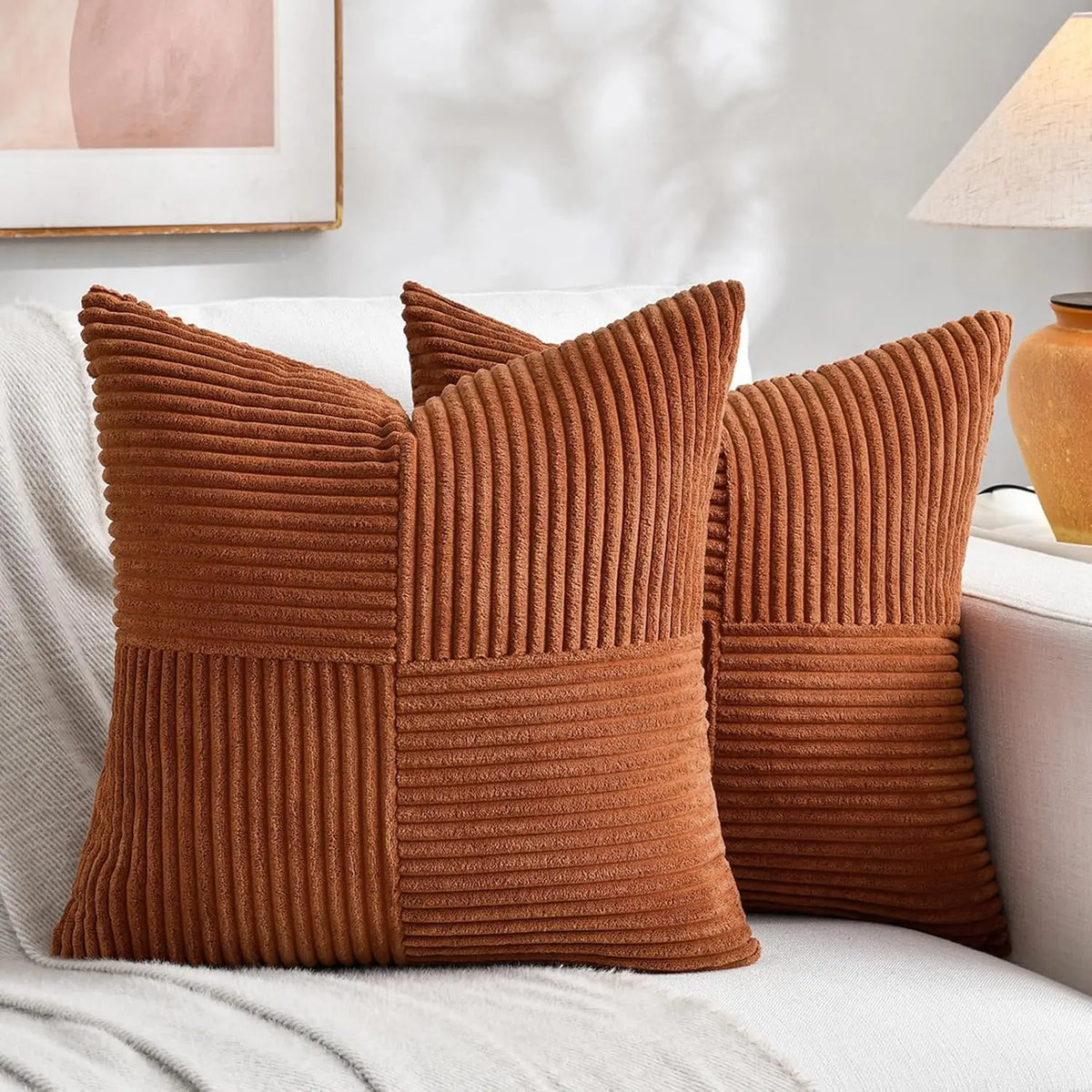Rust corduroy pillow covers on a sofa
