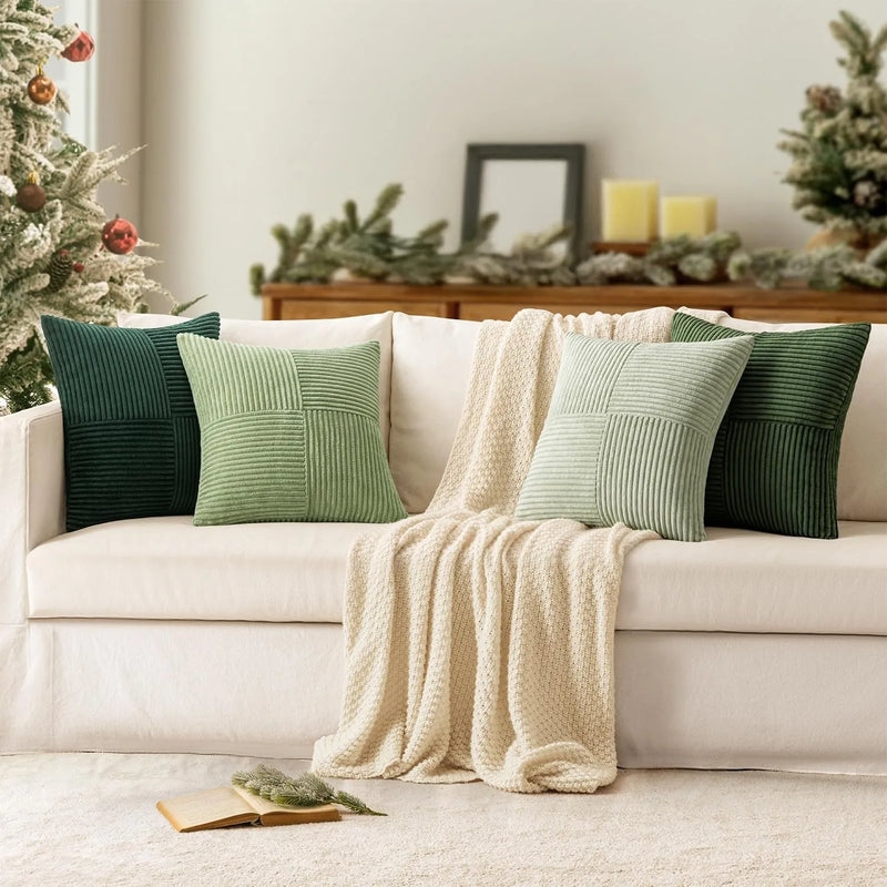 Green corduroy pillow covers styled on a cream sofa