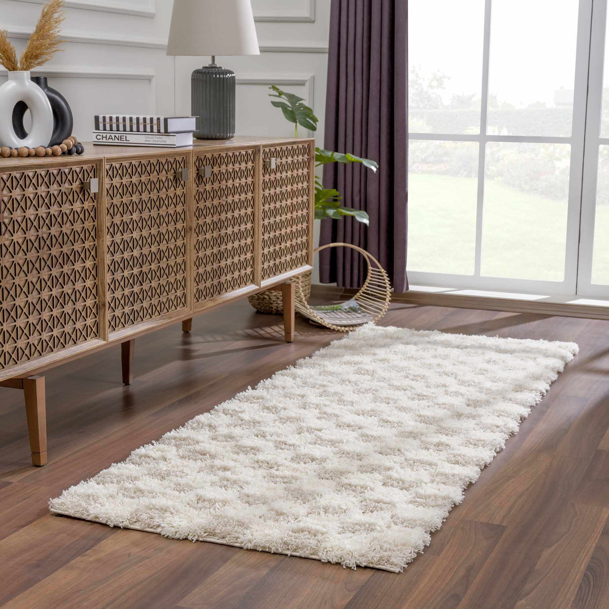Checkered shag runner in front of a wood console