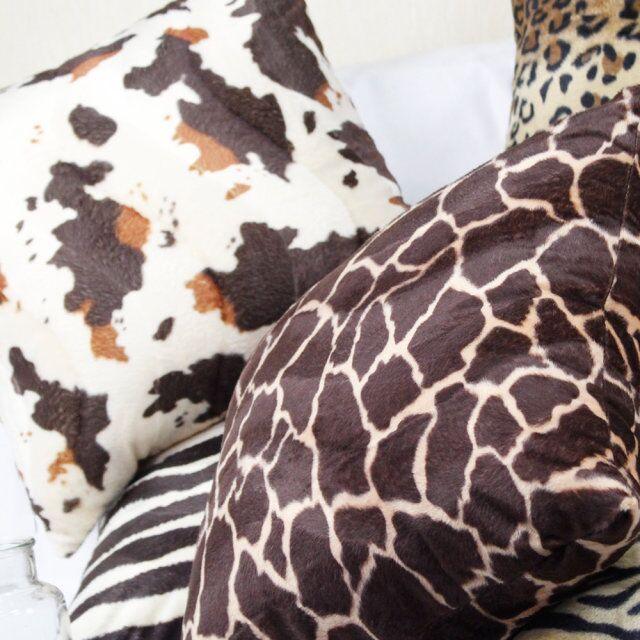 Plush cow and giraffe print pillow covers
