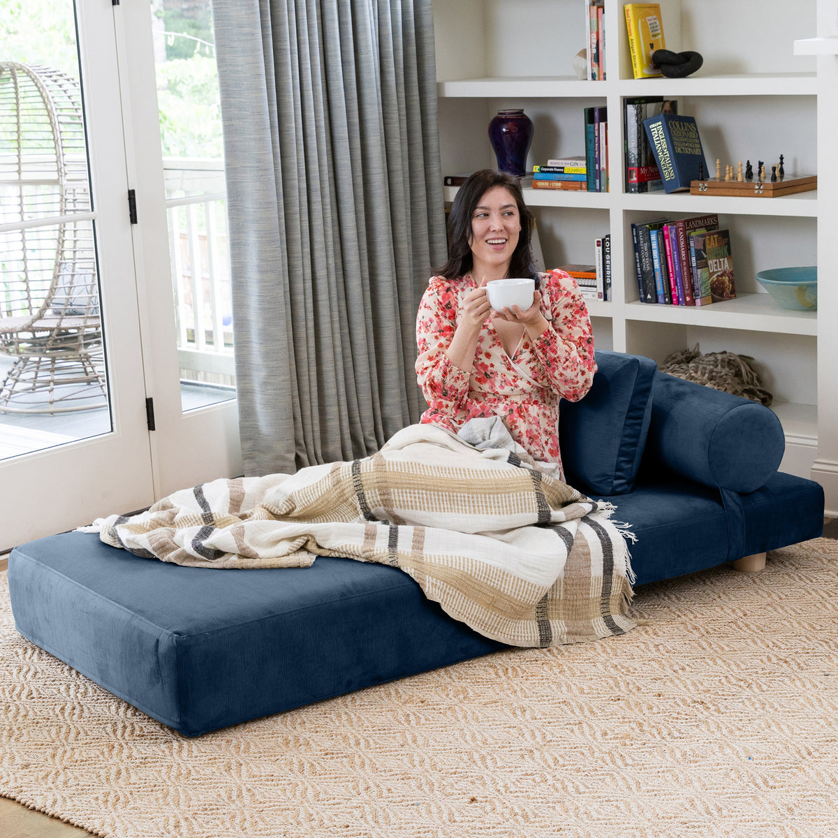 Avida Chair in Indigo Microvelvet, unfolded as a twin bed with bolster and pillow