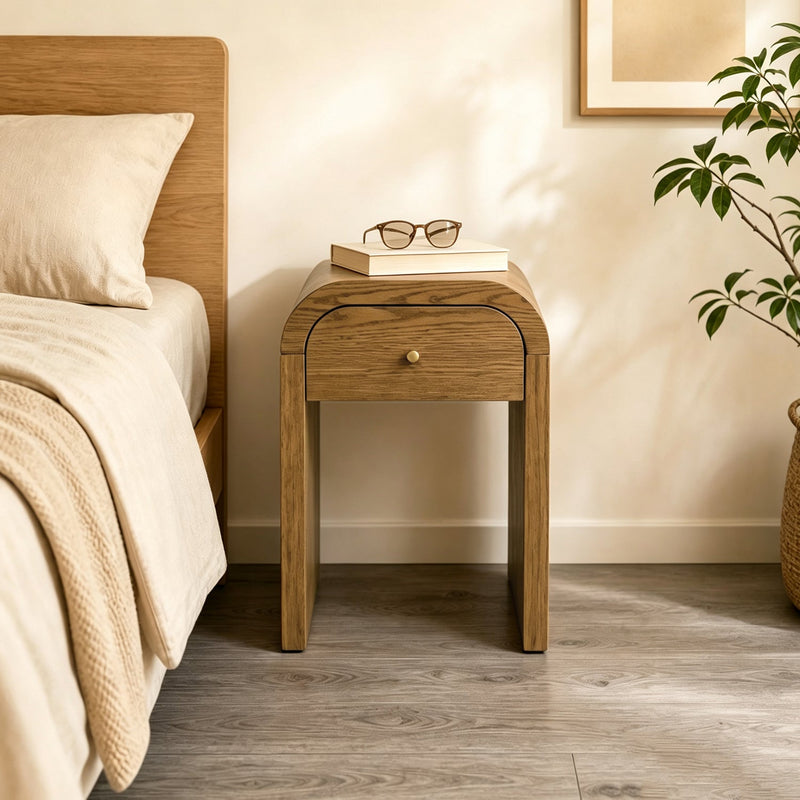 Curved Side Table with Drawer as a nightstand beside a bed
