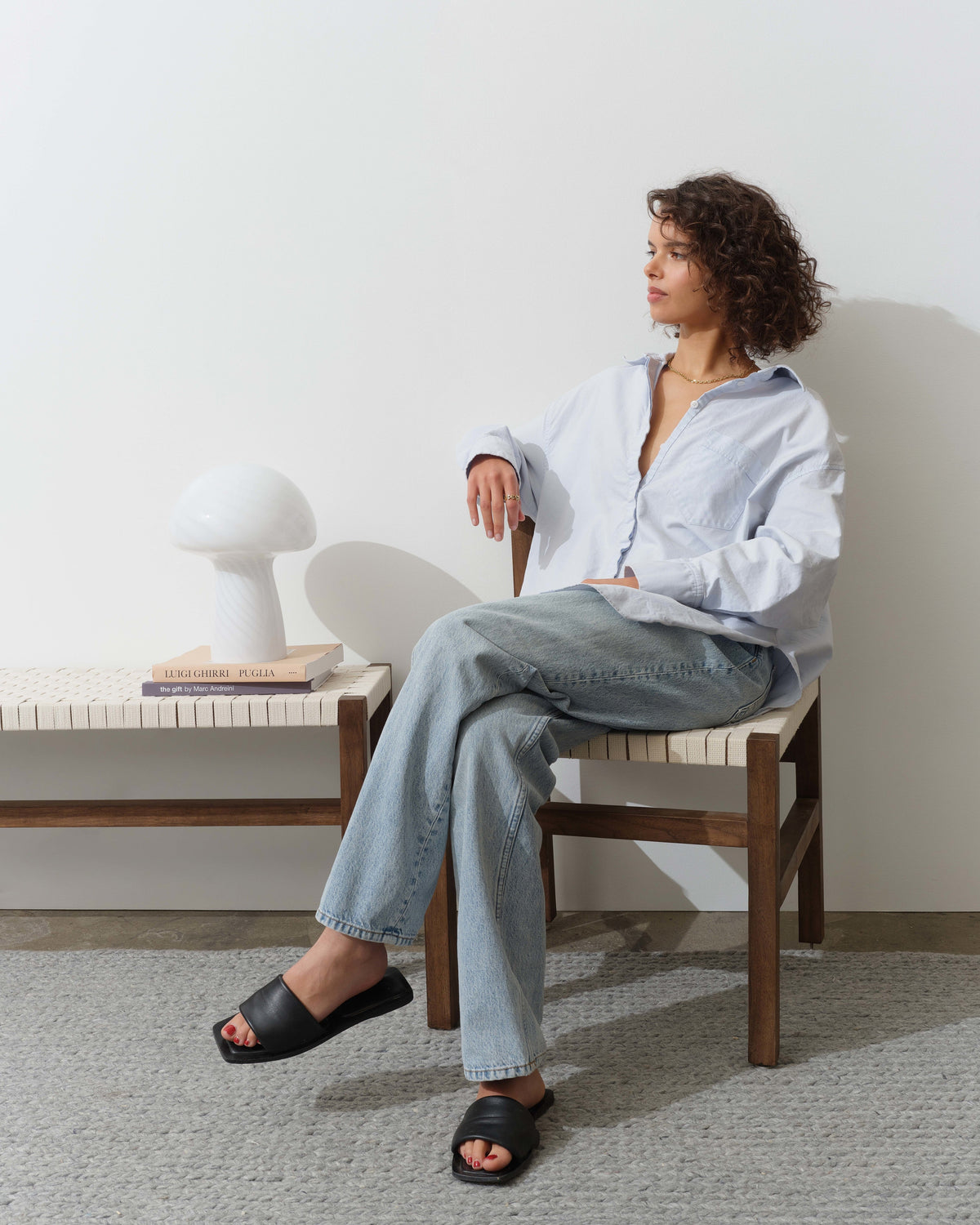 Mushroom Table Lamp on a bench beside a seated woman