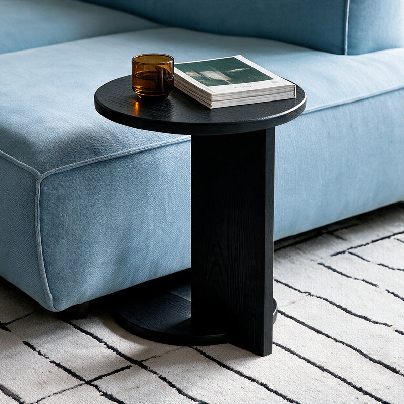 Black Echo Side Table tucked under a sofa