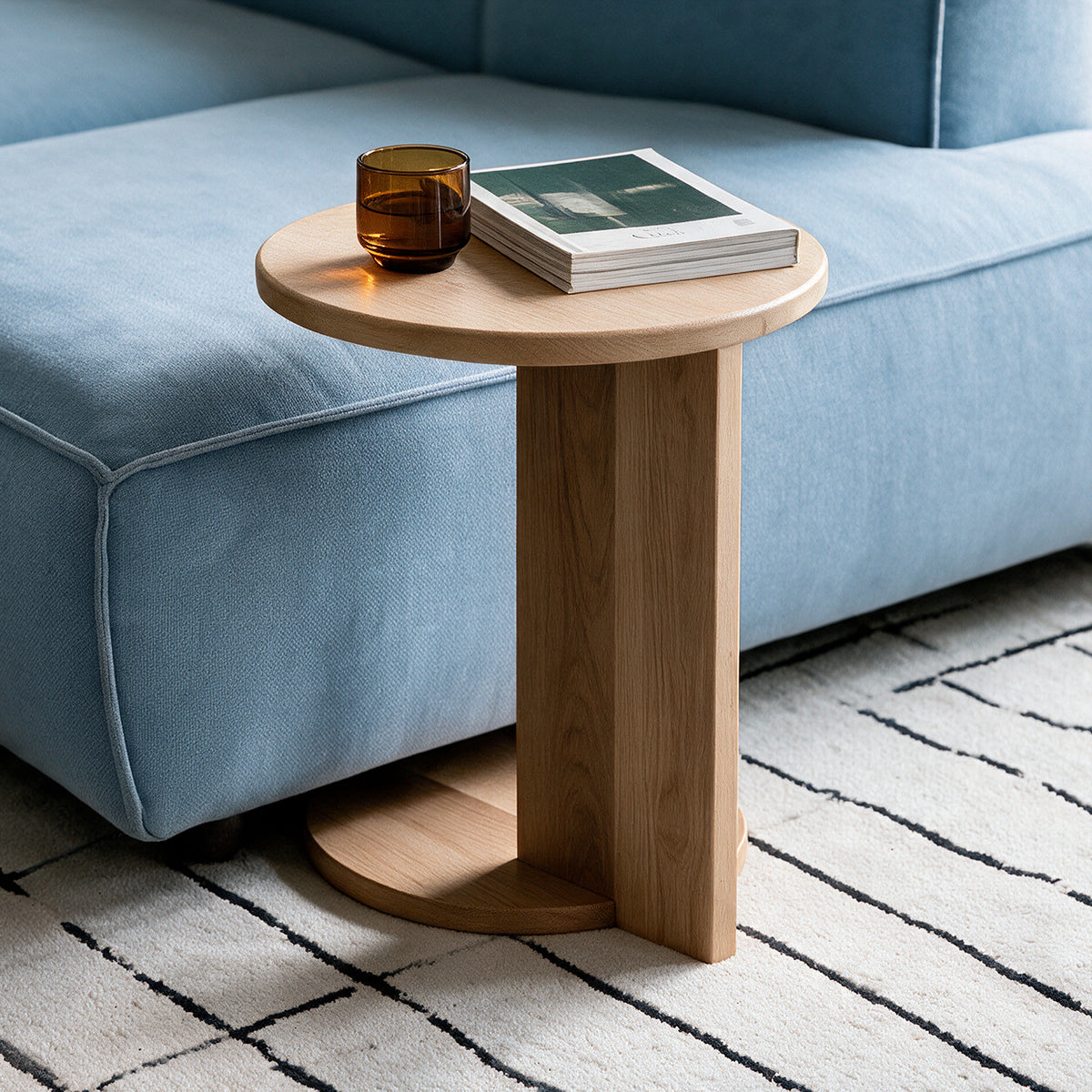 Natural Echo Side Table tucked under a sofa