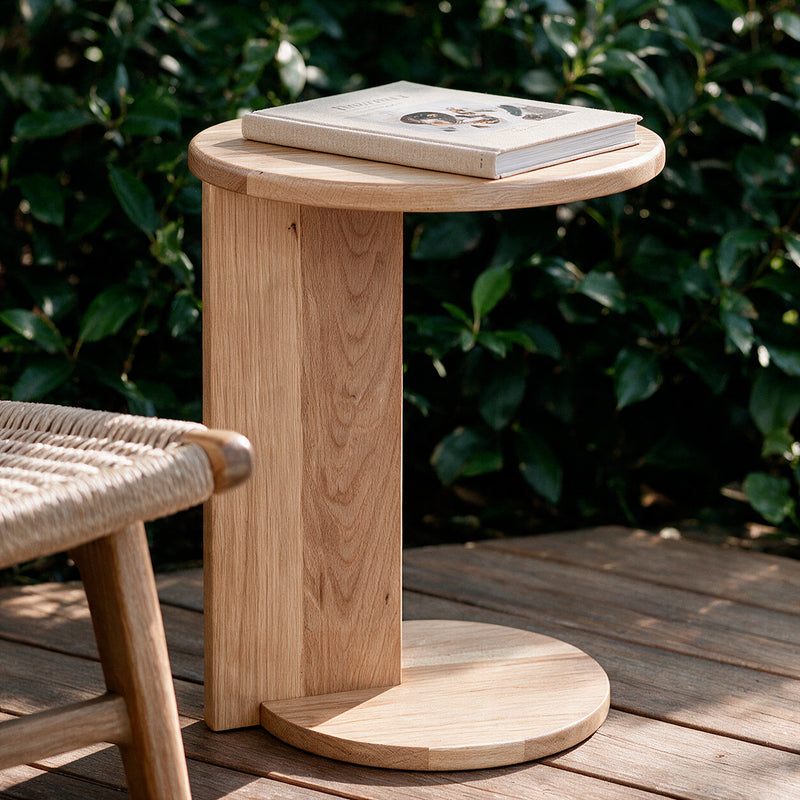 Natural Echo Side Table on a patio with a book