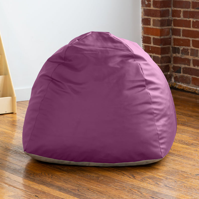Purple bean bag chair on a wooden floor with a brick wall in the background