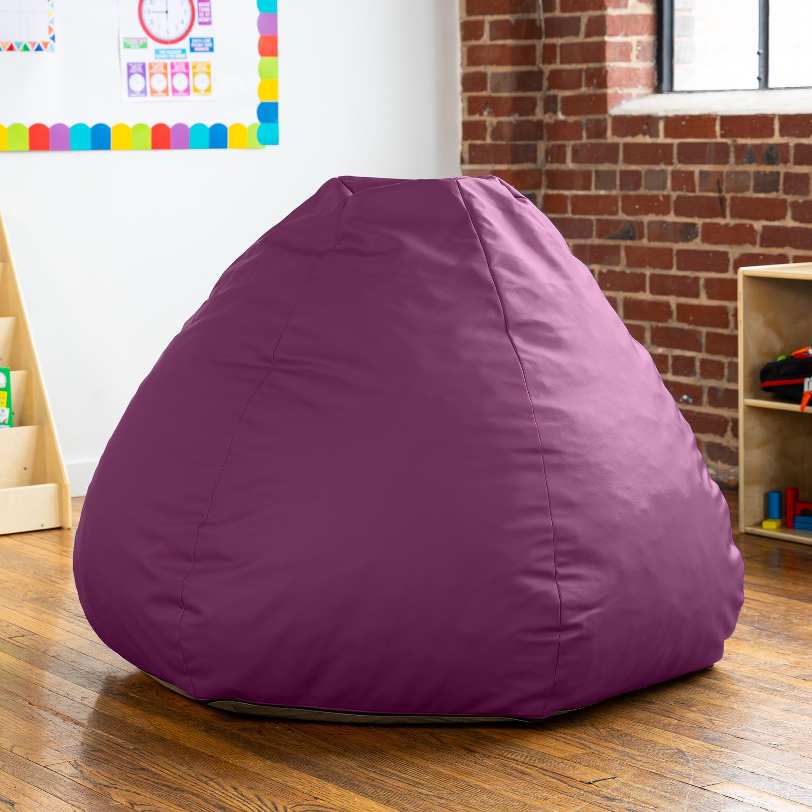 Purple bean bag chair in a room with a brick wall and colorful decorations.