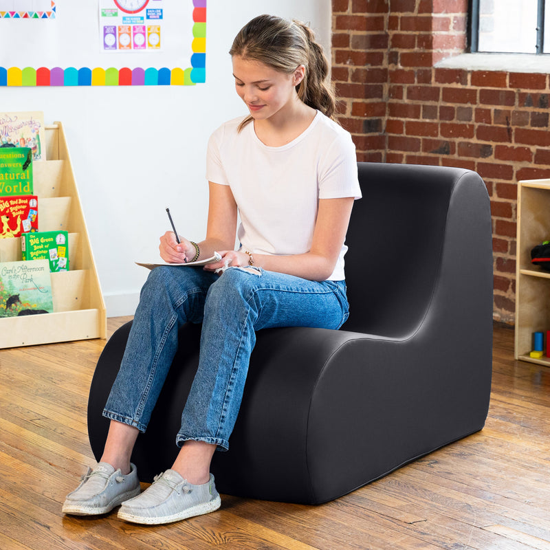Girl sitting on Midtown chair in black in a classroom
