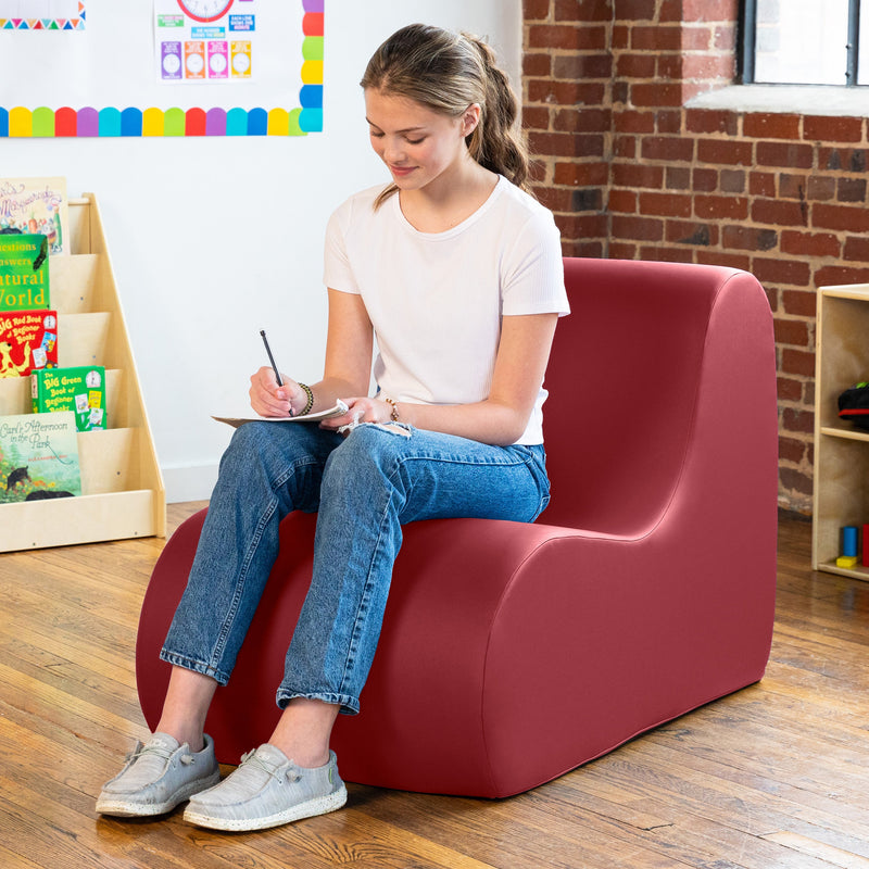 Girl sitting in  Midtown chair in red in a classroom