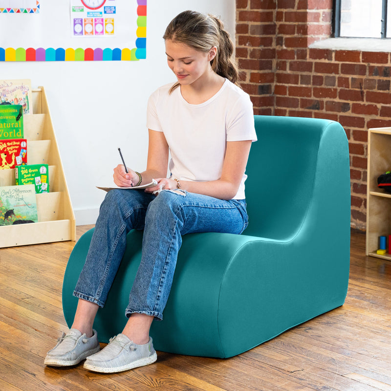 Girl sitting on Midtown chair in blue in a classroom