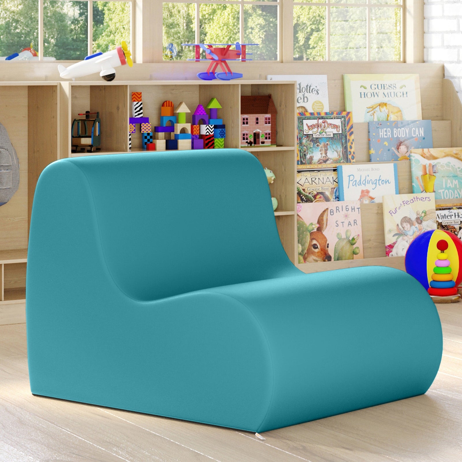 Turquoise children's chair in a room with books and toys