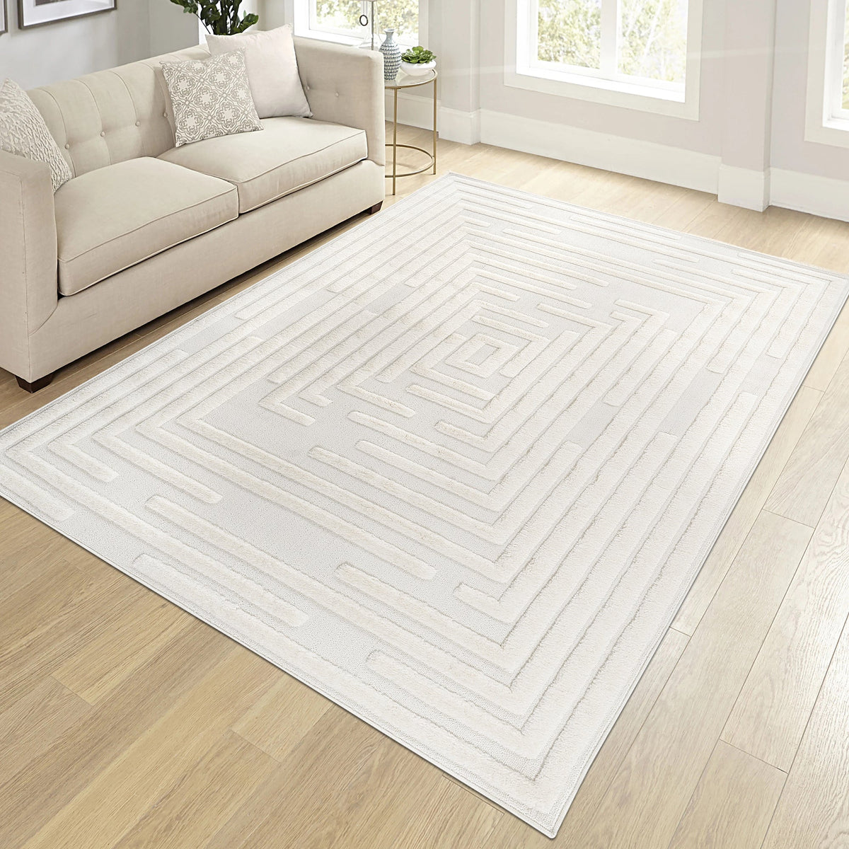 Cream geometric rug in a living room with a cream sofa