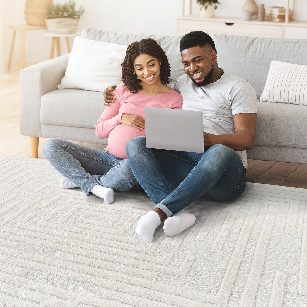 Couple relaxing on the cream geometric rug