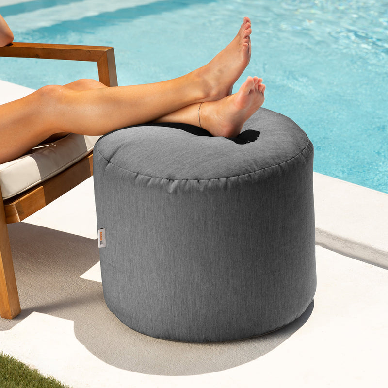 Spring outdoor ottoman in charcoal gray poolside