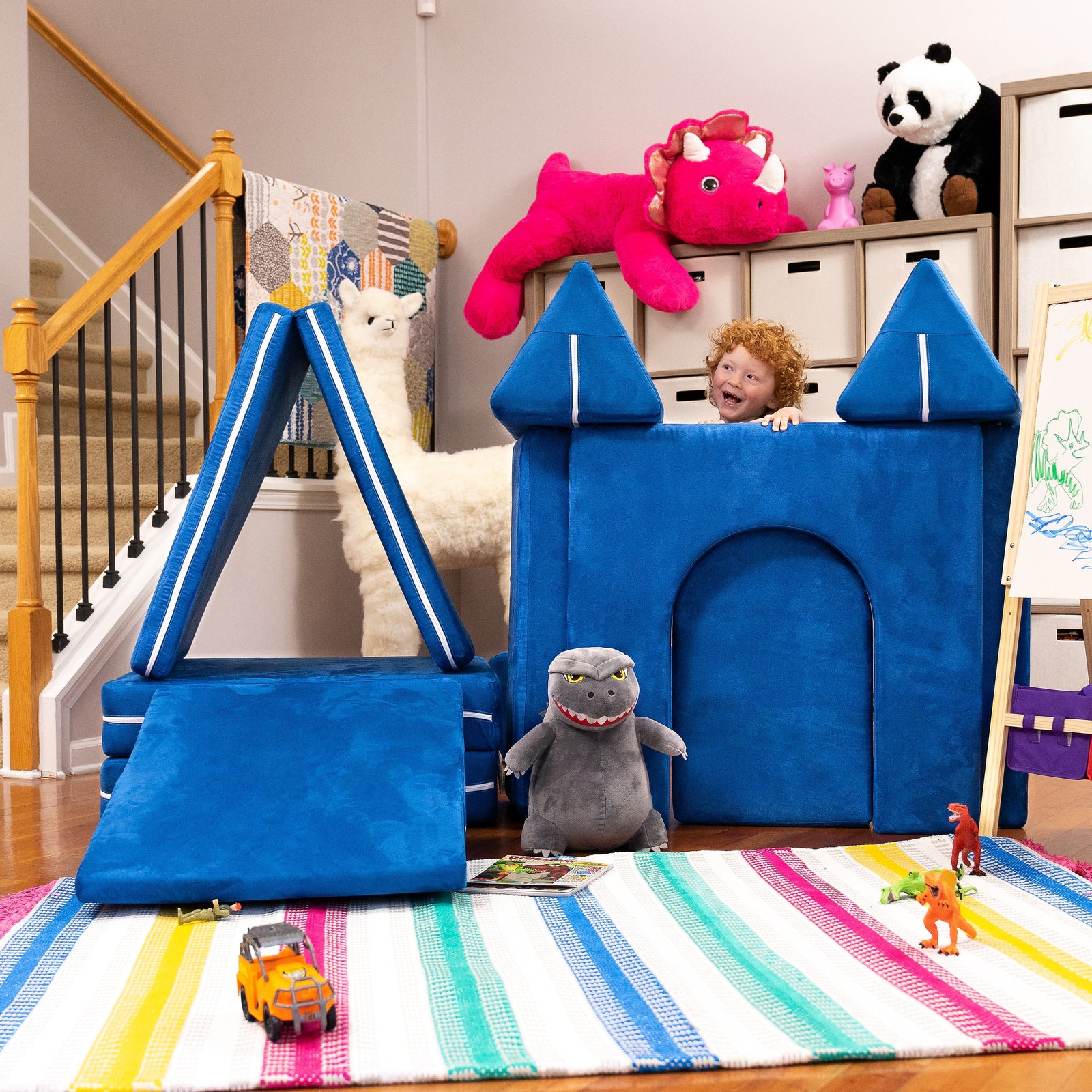 Child playing behind Zipline Castle Gate with Playscape sofa 