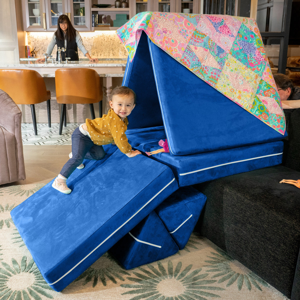 Child playing on blue Playscape modular play sofa