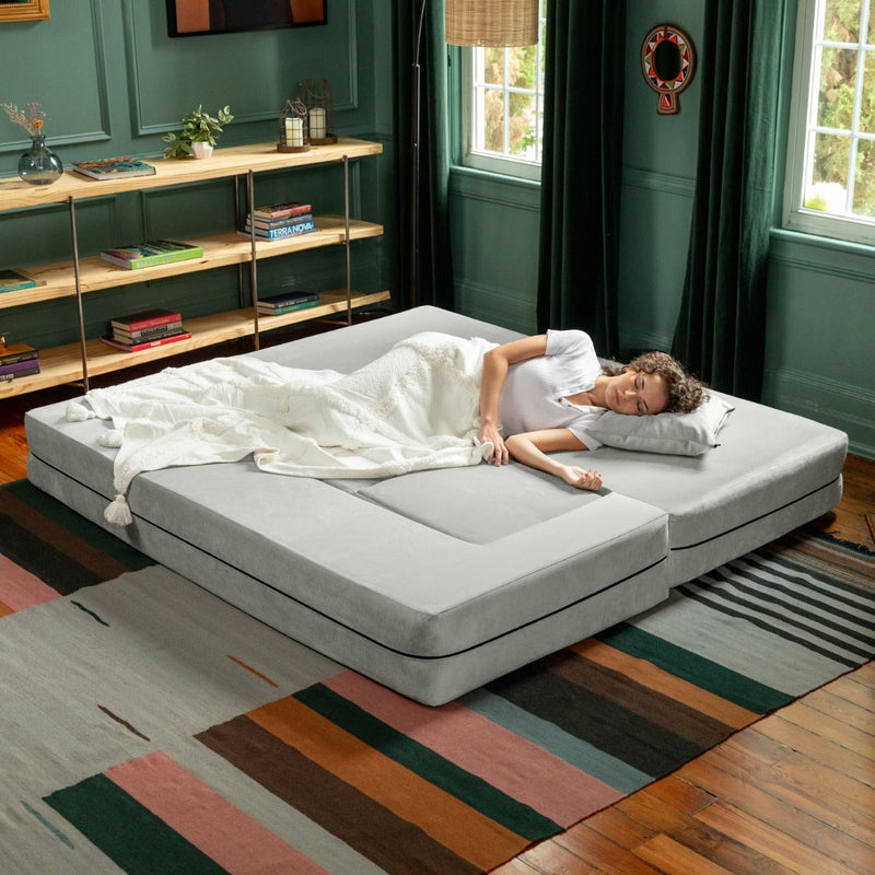 Woman sleeping on the Zipline Convertible Sofa Microvelvet Ice